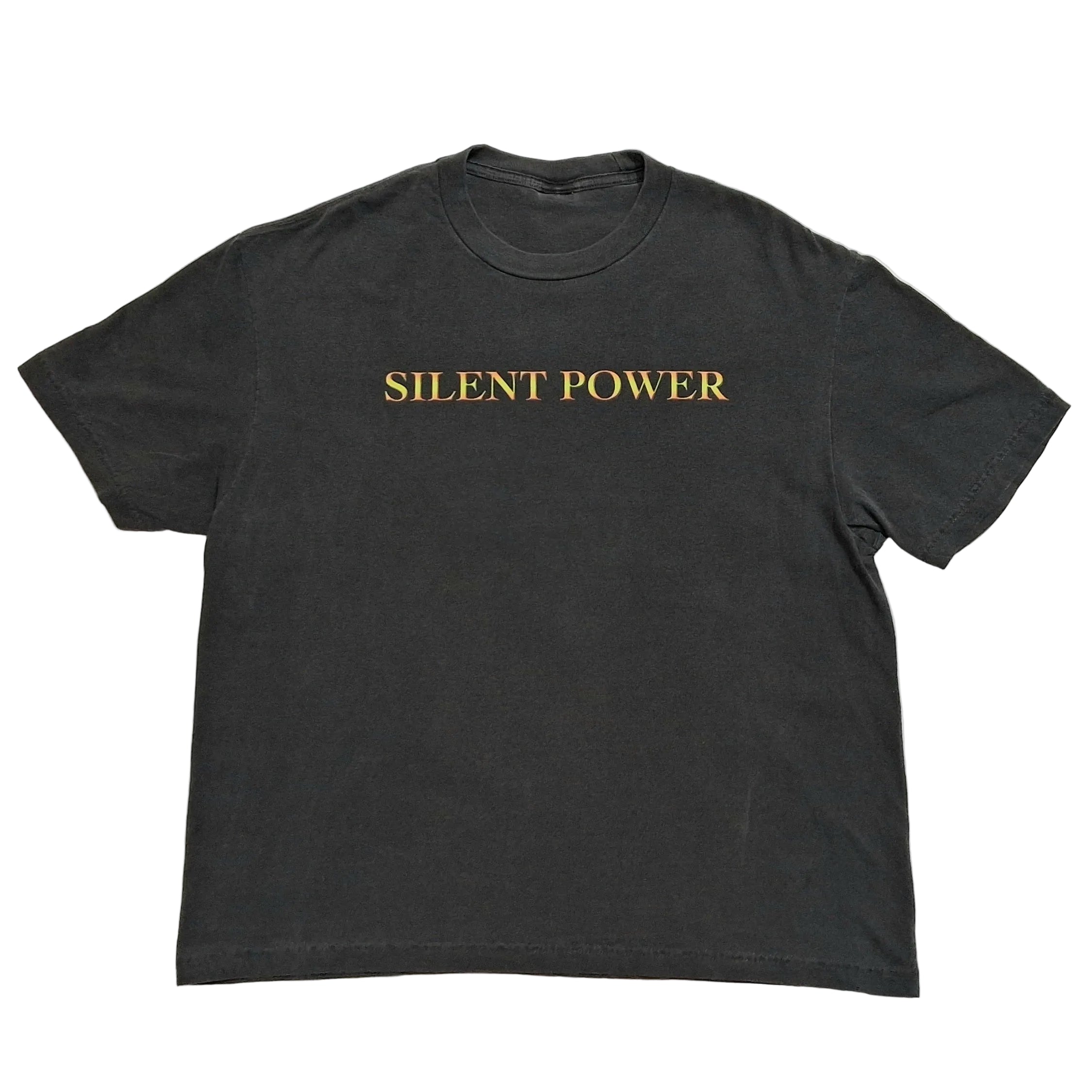 A dark charcoal gray short-sleeve t-shirt with the words 'SILENT POWER' printed in gold serif lettering across the chest, laid flat against a light gray background.