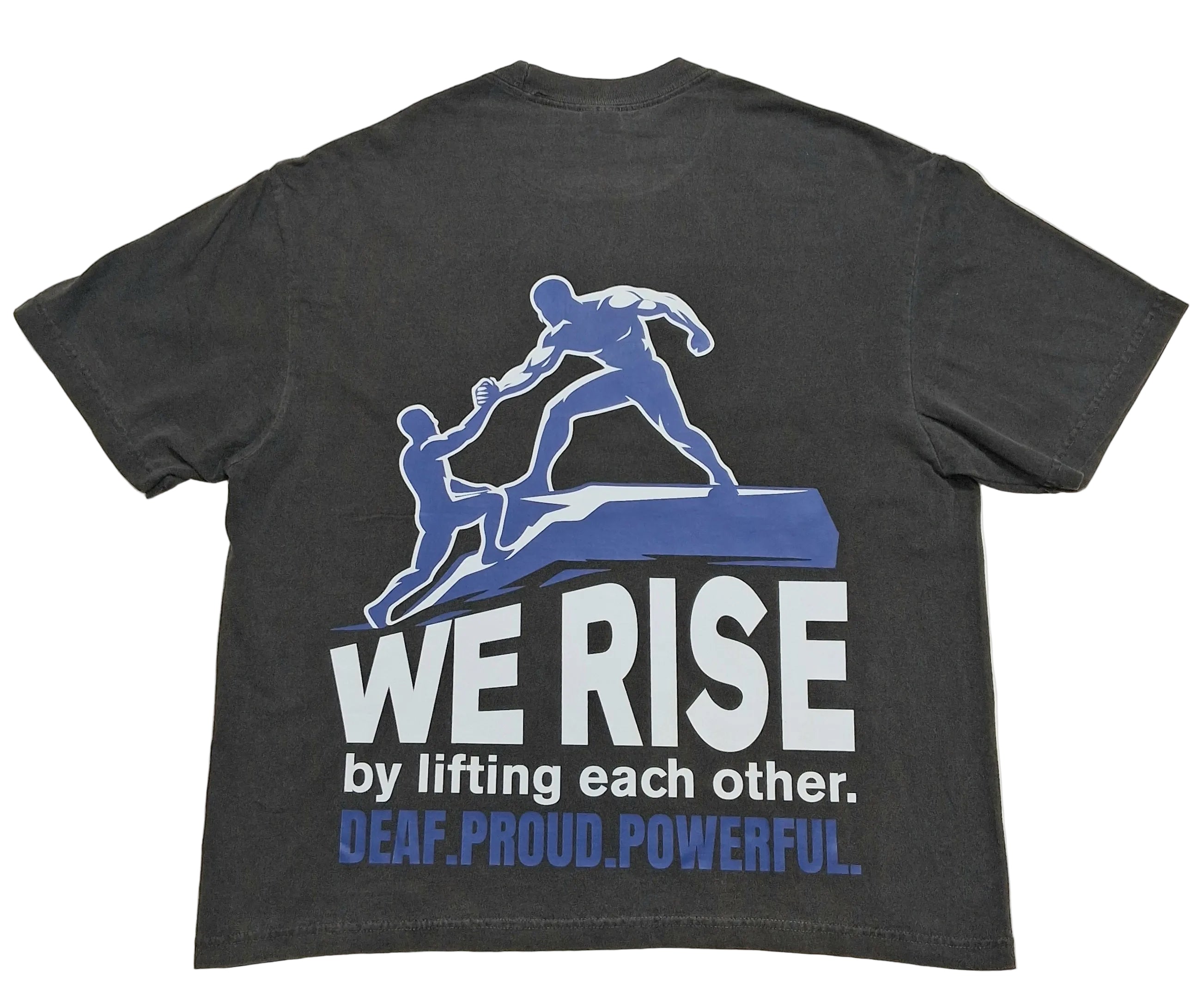 A dark charcoal gray t-shirt showing the back side, which features a graphic of two blue figures lifting each other up. Below the graphic, the text reads 'WE RISE by lifting each other.